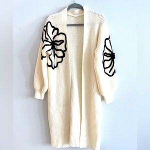 Elegant Cream Open-Front Sweater with Black Floral Design